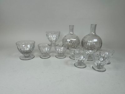 a lot of glass vases and glasses on the table