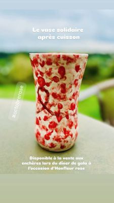 a glass of yogurt sitting on a table with a view of the ocean