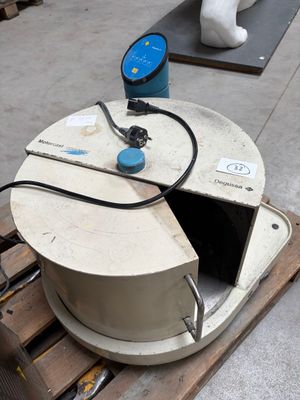 a white object sitting on a pallet next to a blue object