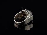 a close up of a silver ring on a black surface