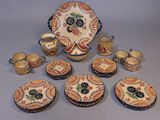 many pieces of pottery that are sitting on a table