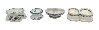 four pieces of pottery that are sitting on a white surface