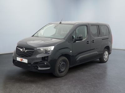 the grey van is parked in a room with a black floor