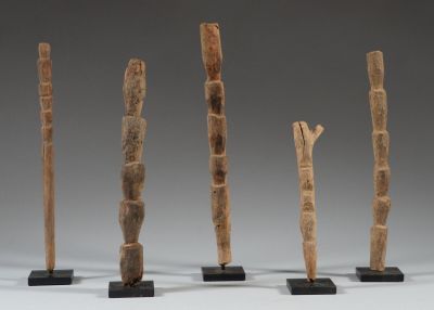 four pieces of wood are arranged in a row on black stands