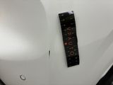 a close up of a white car with a black sticker on it