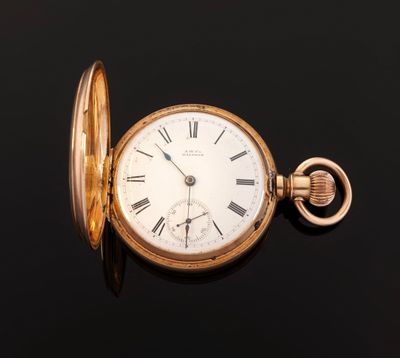 an antique pocket watch with roman numerals on a black surface