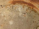 a close up of a brown vase with writing on it