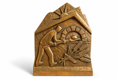 bronze sculpture of a man and woman in a hut with wheat in it