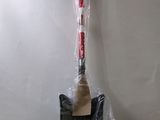 a red and black shovel sitting on a plastic bag