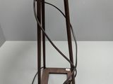 a metal stand with a lamp on it on a white surface
