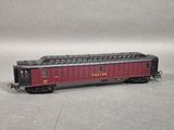 an image of a red train car sitting on top of a gray surface