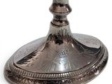 a silver chalicet on a stand on a white background