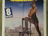 an image of a movie poster with a woman sitting on a chair in front of a crowd