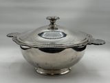 a silver plated bowl with a lid and a handle