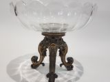 a glass bowl on a stand on a white surface