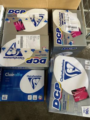 boxes of cleaning supplies are stacked on a carton in a store
