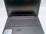 the laptop is open on a white surface with a keyboard and mouse
