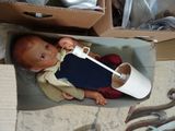 a baby that is sitting in a box with a toothbrush