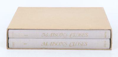 two books are stacked on top of each other on a white surface