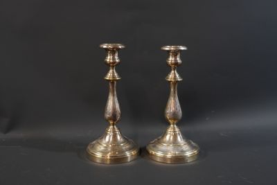 pair of antique brass candlesticks on a black background