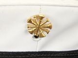 an image of a close up of a white hat with a gold flower on it