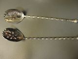 two spoons that are sitting next to each other