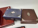 several different types of leather cases sitting on top of a white table
