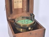 a small wooden box with a compass inside of it