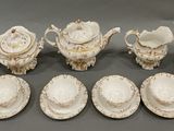 many different types of porcelain dishes and cups on the table