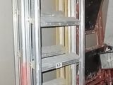 a man standing in a room with a ladder in it