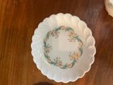 a white plate with a blue and gold design on it