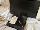 a laptop computer sitting on top of a pile of papers