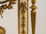 a gold clock sitting on top of a marble table