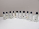 six bottles of perfume are lined up on a white surface