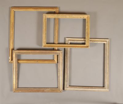 quatre cadres en bois sont disposés en rangée sur un mur