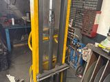 a fork lift in a garage with a lot of tools