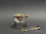two spoons and a bowl sitting on a table