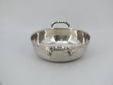 silver plated bowl with handles and handles on a white surface