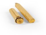a pair of gold colored pens sitting next to each other on a white surface