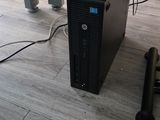 a computer sitting on the floor next to a chair