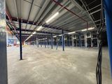 the inside of an empty warehouse with a lot of blue poles