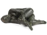 sculpture en bronze représentant un homme allongé sur le dos sur une surface blanche