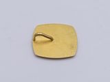 gold plated square with a ring on top of it on a white surface