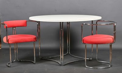 two red chairs and a white table in a room