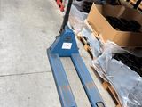 a forklift that is sitting on the floor in a warehouse