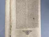 an old book with writing on it sitting on top of a table