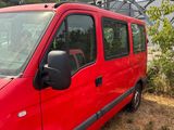 a red van that is parked next to a red fire hydrant