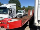 many trucks that are parked in a lot together
