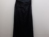 a black dress hanging on a hanger in a room