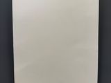 an empty piece of paper hanging on a black wall